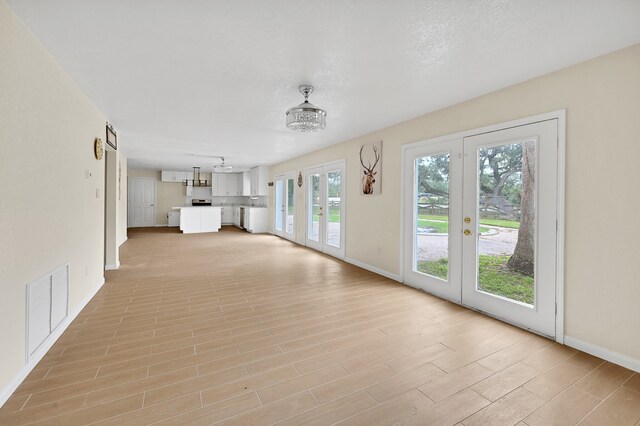 unfurnished living room featuring french doors