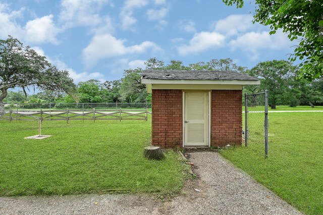 view of shed / structure featuring a lawn