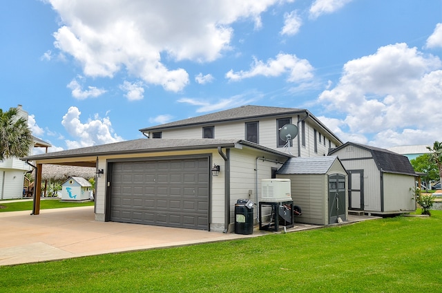 exterior space with a garage, a carport, a front yard, and a storage shed