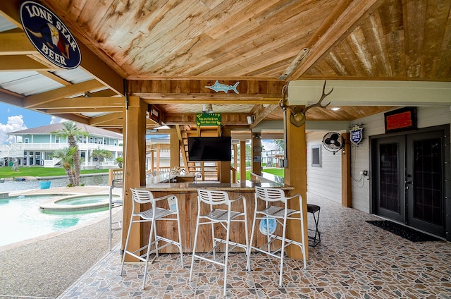 view of terrace featuring an outdoor bar and french doors