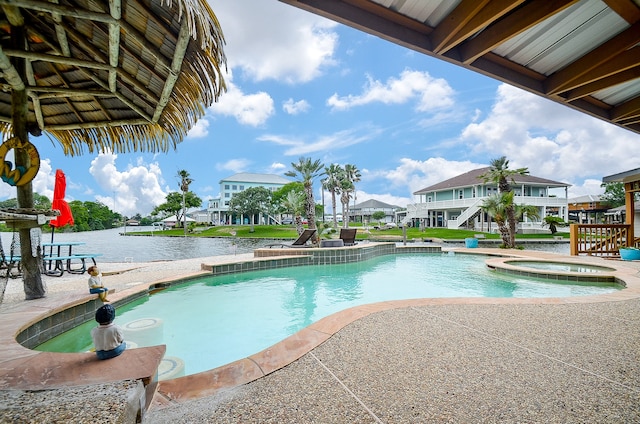 view of swimming pool featuring an in ground hot tub