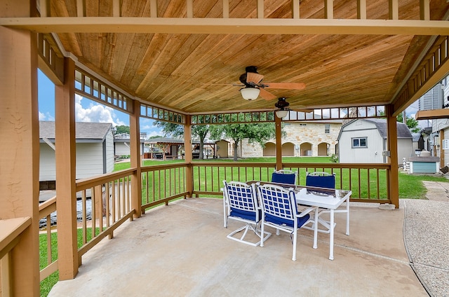 view of terrace with ceiling fan and a storage unit