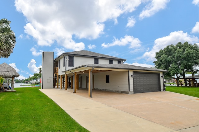 view of front of home featuring a front yard, a carport, and a garage