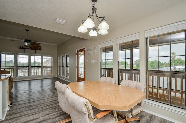 dining area with ceiling fan with notable chandelier, a textured ceiling, and dark wood-type flooring