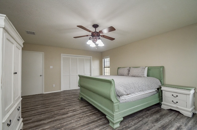 bedroom with dark hardwood / wood-style floors and ceiling fan