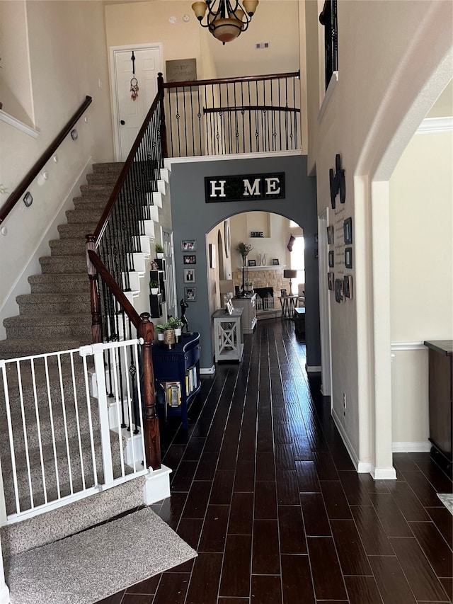 foyer featuring ornamental molding, a high ceiling, and hardwood / wood-style floors