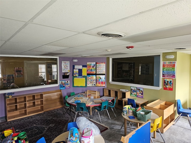 rec room with a paneled ceiling