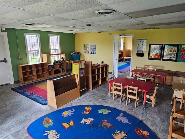 game room with a drop ceiling