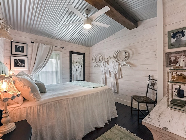 bedroom with vaulted ceiling with beams, ceiling fan, dark wood-type flooring, and wood walls