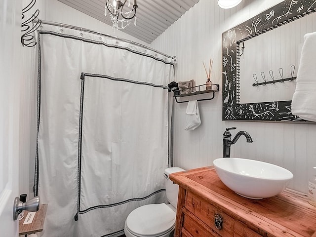 bathroom featuring vanity, vaulted ceiling, and toilet