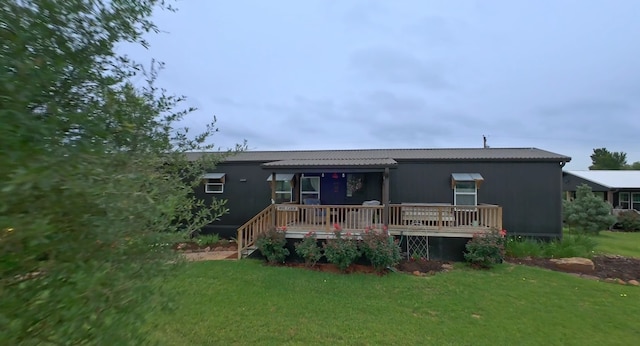 view of front facade featuring a front lawn and a deck