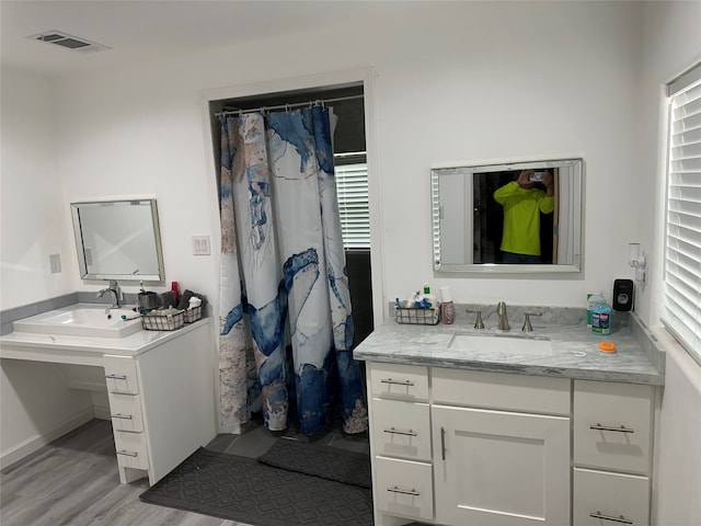 bathroom featuring hardwood / wood-style flooring and vanity