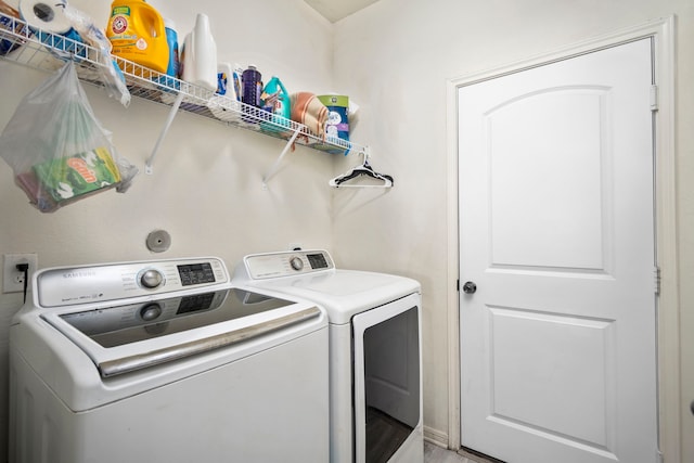 clothes washing area featuring wood-type flooring and independent washer and dryer