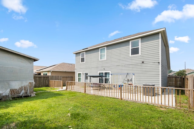 back of house with a yard, central air condition unit, and a patio area