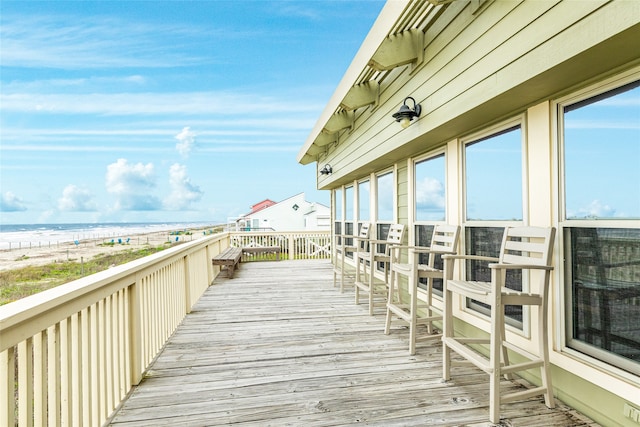 wooden terrace featuring a water view