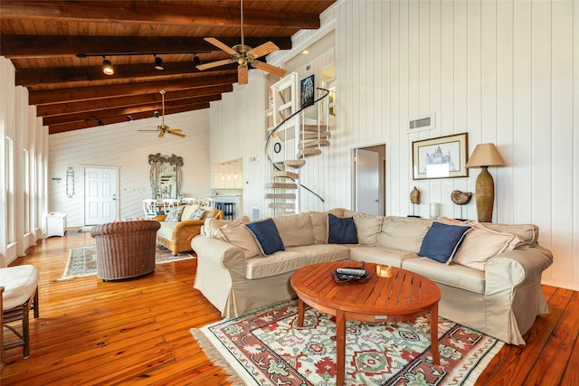 living room with hardwood / wood-style floors, ceiling fan, high vaulted ceiling, and wood ceiling