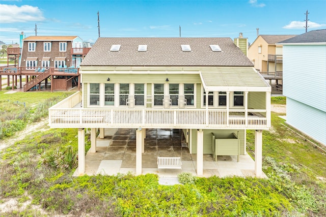 rear view of property with a patio and a wooden deck