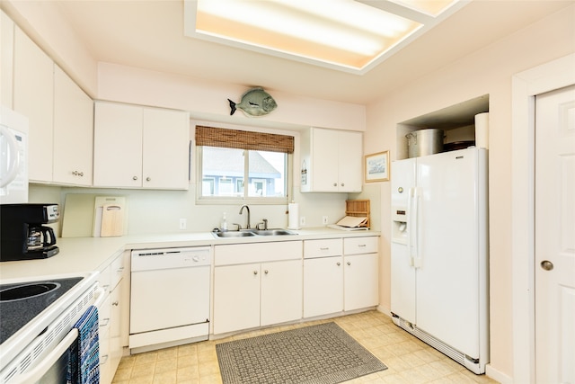 kitchen with white cabinets, sink, white appliances, and light tile flooring