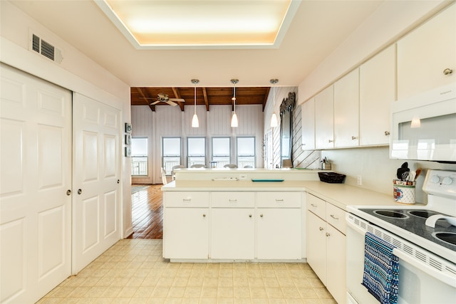 kitchen featuring hanging light fixtures, white cabinets, white appliances, kitchen peninsula, and light tile floors