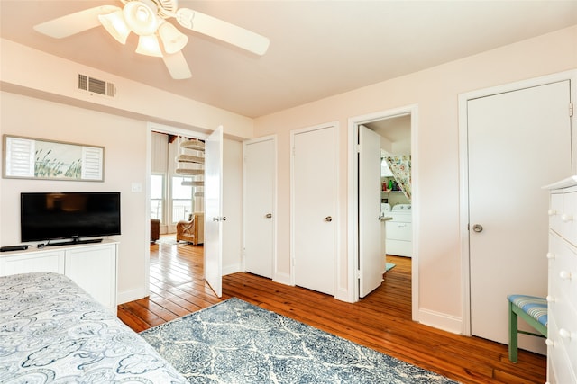 bedroom featuring hardwood / wood-style floors, ceiling fan, and washer / clothes dryer