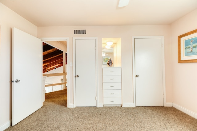 unfurnished bedroom with light colored carpet