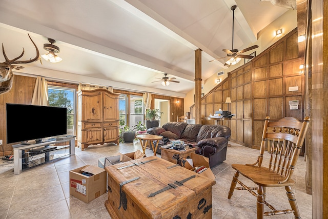 living room with beamed ceiling, ceiling fan, wooden walls, high vaulted ceiling, and light tile patterned floors