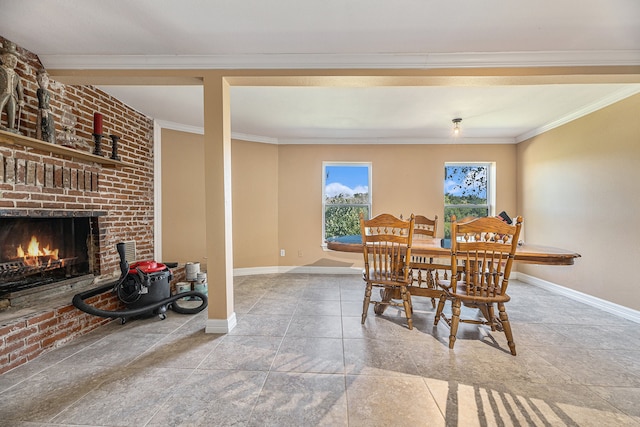 dining space featuring baseboards, a brick fireplace, and ornamental molding