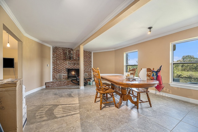 dining area featuring a brick fireplace, plenty of natural light, and crown molding