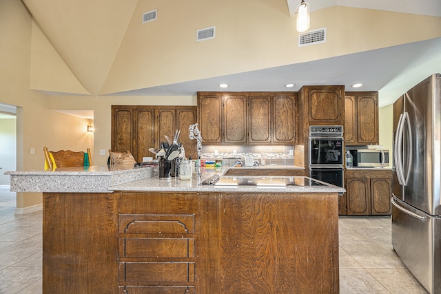 kitchen featuring light tile patterned flooring, a center island with sink, high vaulted ceiling, and black appliances