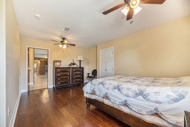 bedroom with visible vents, ceiling fan, baseboards, hardwood / wood-style floors, and a closet