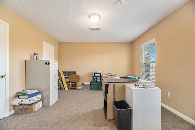 office area featuring visible vents, baseboards, a textured ceiling, and carpet flooring