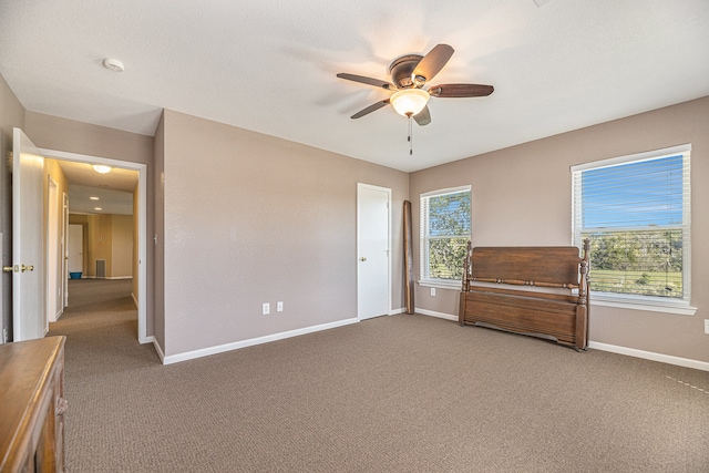 unfurnished bedroom with carpet flooring, baseboards, and ceiling fan