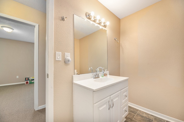 bathroom featuring baseboards and vanity