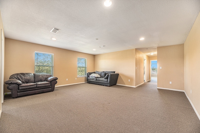 living room featuring visible vents, baseboards, and carpet flooring