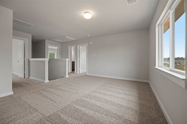 empty room with a healthy amount of sunlight and light colored carpet