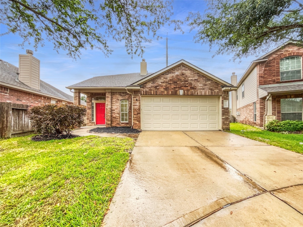 view of front facade featuring a front yard and a garage