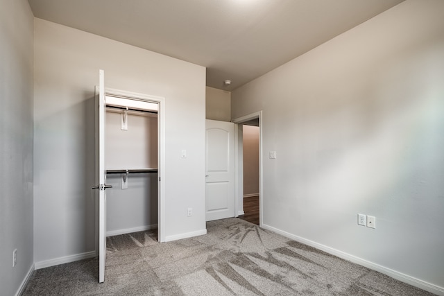 unfurnished bedroom featuring a closet and carpet floors