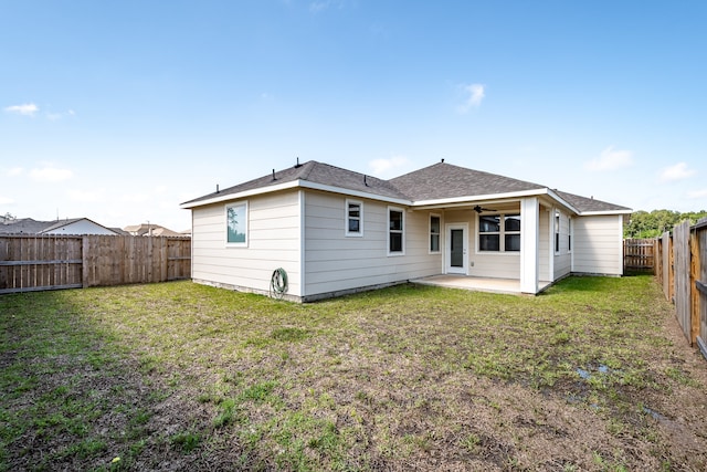 rear view of house featuring a patio area and a yard