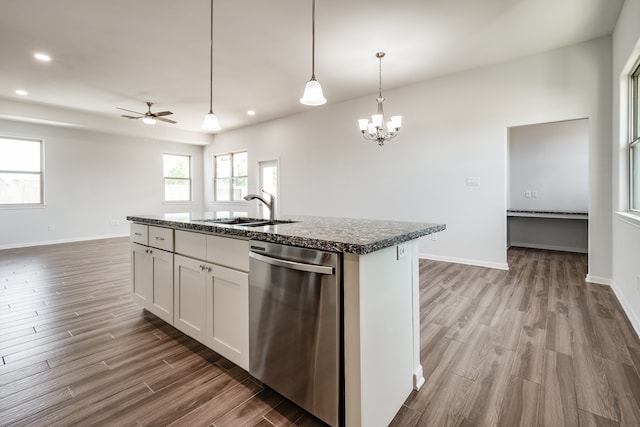 kitchen featuring a center island with sink, dishwasher, ceiling fan with notable chandelier, hardwood / wood-style flooring, and sink