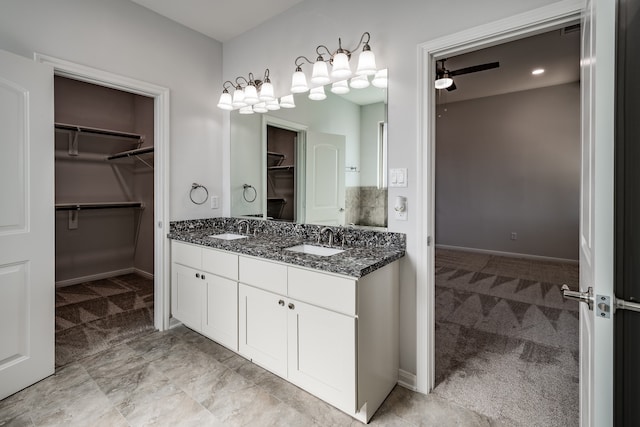 bathroom with double sink vanity, ceiling fan, and tile floors