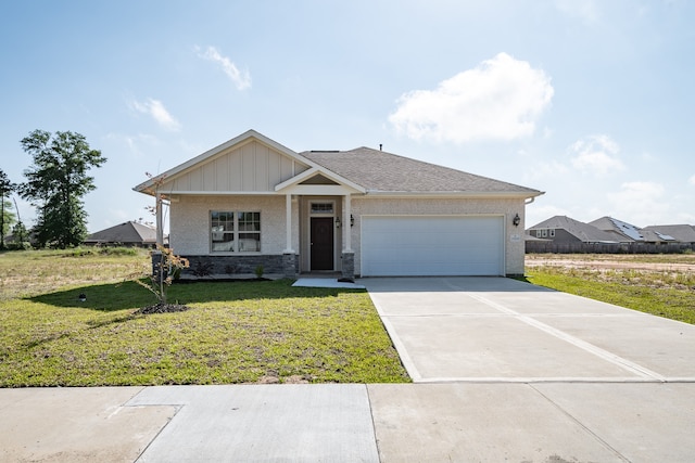 view of front of house with a front yard and a garage