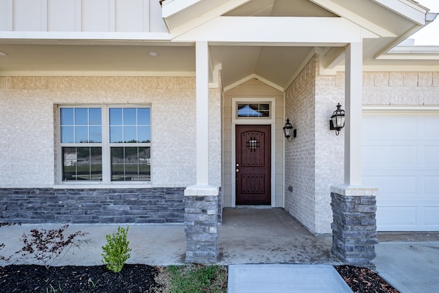 doorway to property with a garage