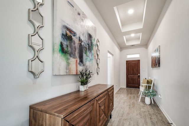 interior space with light hardwood / wood-style flooring and a tray ceiling