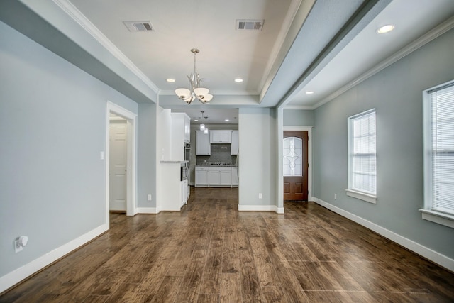 interior space featuring a notable chandelier, crown molding, and dark wood-type flooring