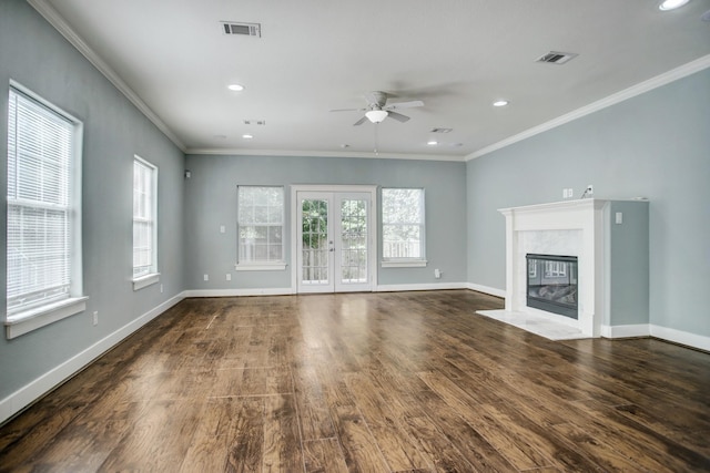 unfurnished living room with a fireplace, french doors, crown molding, hardwood / wood-style floors, and ceiling fan