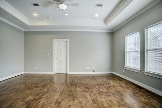 unfurnished room featuring ornamental molding, a raised ceiling, ceiling fan, and hardwood / wood-style flooring