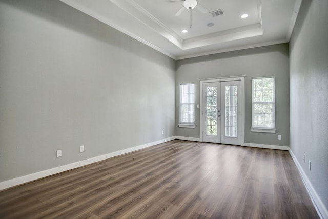 spare room with french doors, a tray ceiling, and dark hardwood / wood-style floors