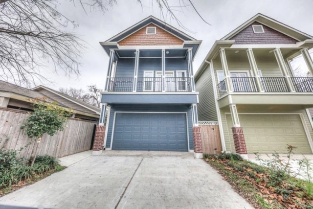 view of front of property featuring a balcony and a garage