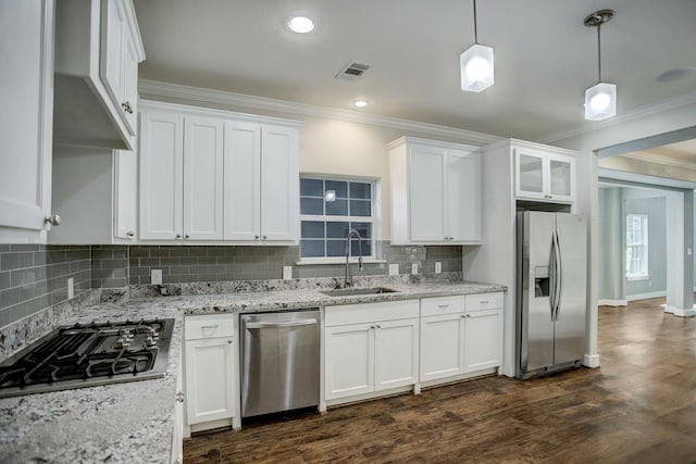 kitchen featuring white cabinets, sink, stainless steel appliances, dark hardwood / wood-style floors, and pendant lighting