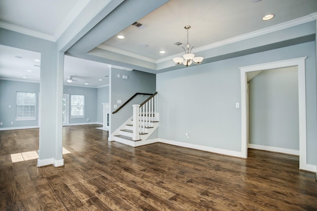 unfurnished room with dark wood-type flooring, a tray ceiling, a chandelier, and ornamental molding